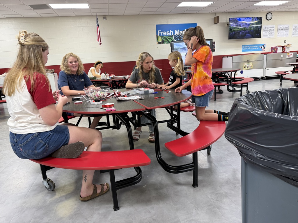 students and volunteers make bracelets on family night