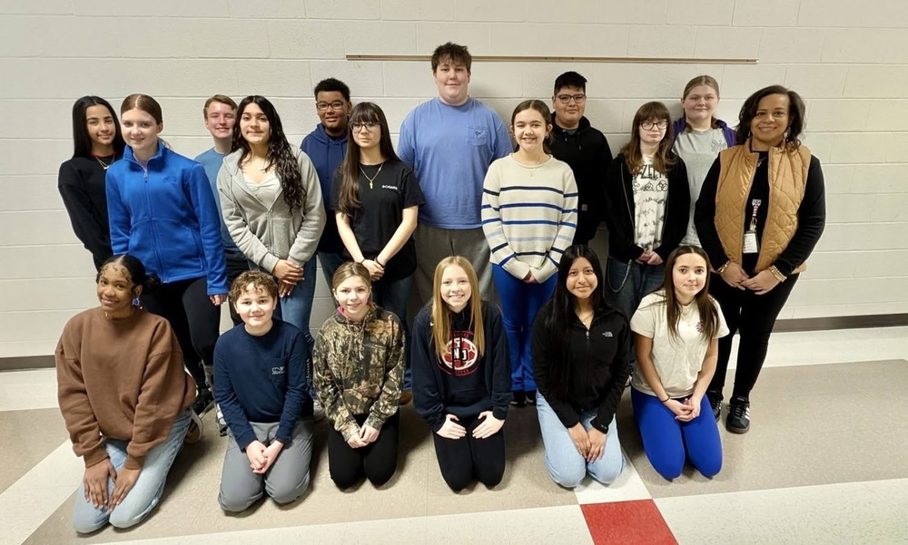 Picture of a group of chorus students and choir director Ms. Crouch