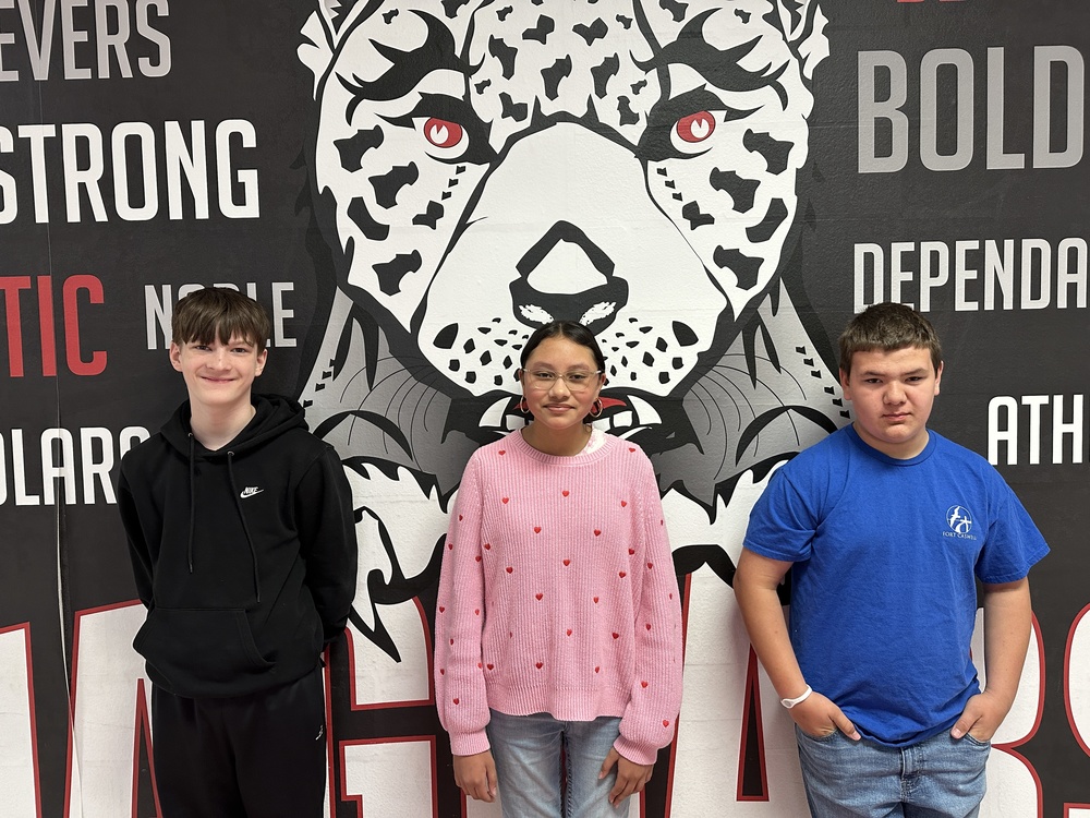 3 7th graders standing in front of the jaguar mural 