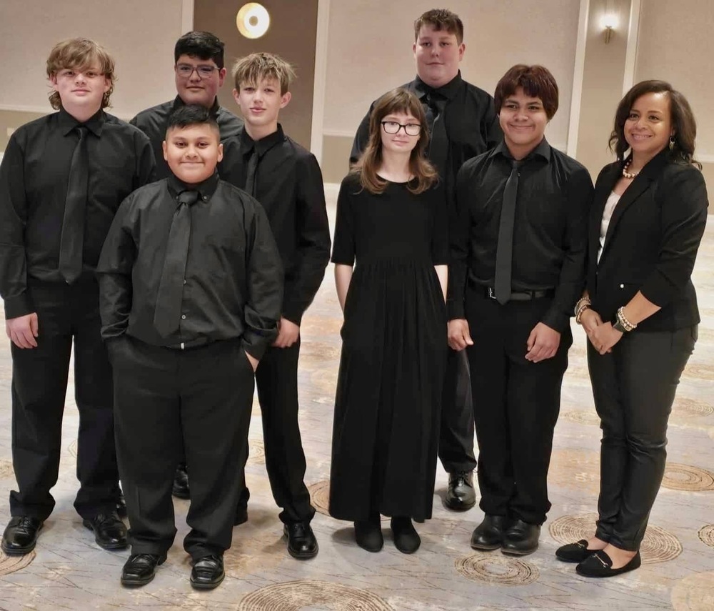 Ms. crouch the chorus director and her honors chorus students 