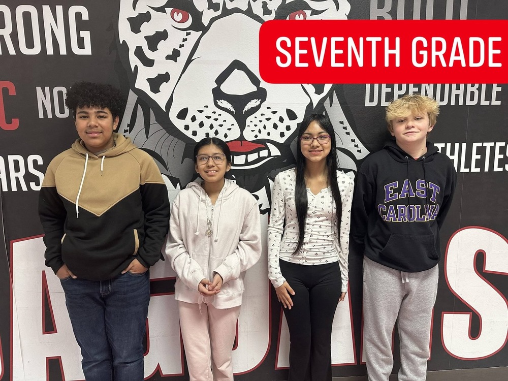 4 7th graders standing in front of the jaguar mural 