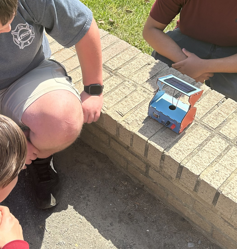 Students testing solar device,