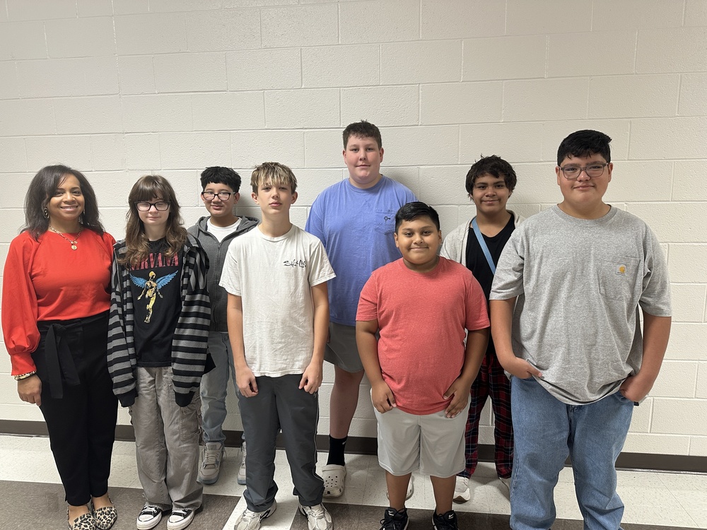 Picture of 7 chorus students and the chorus teacher