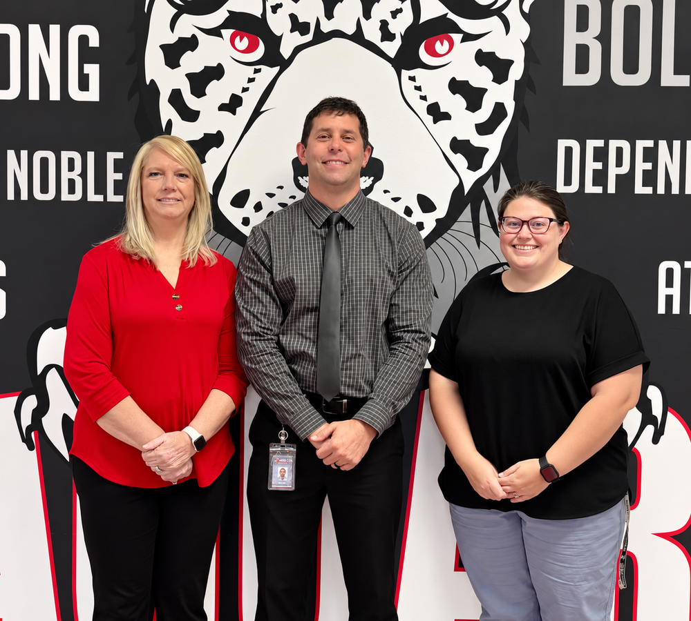 picture of jan sullivan, tj parrish, and bridget brown in front of the jaguar mural 