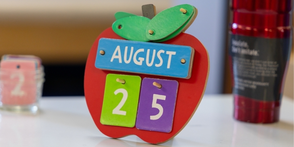 An apple on a desk for the first day of school.
