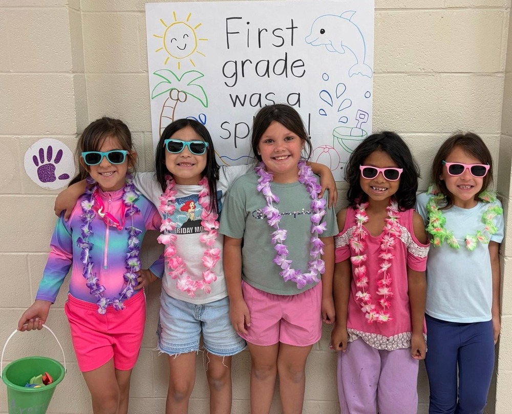 Students standing in front of sign that says First Grade was a Splash