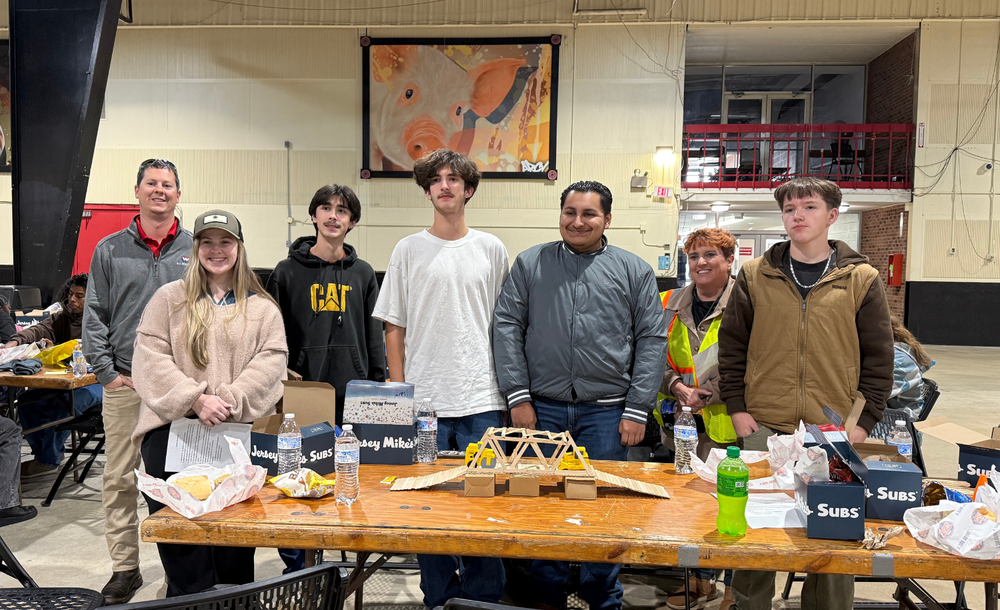 SSS students standing in front of their prize-winning model bridge
