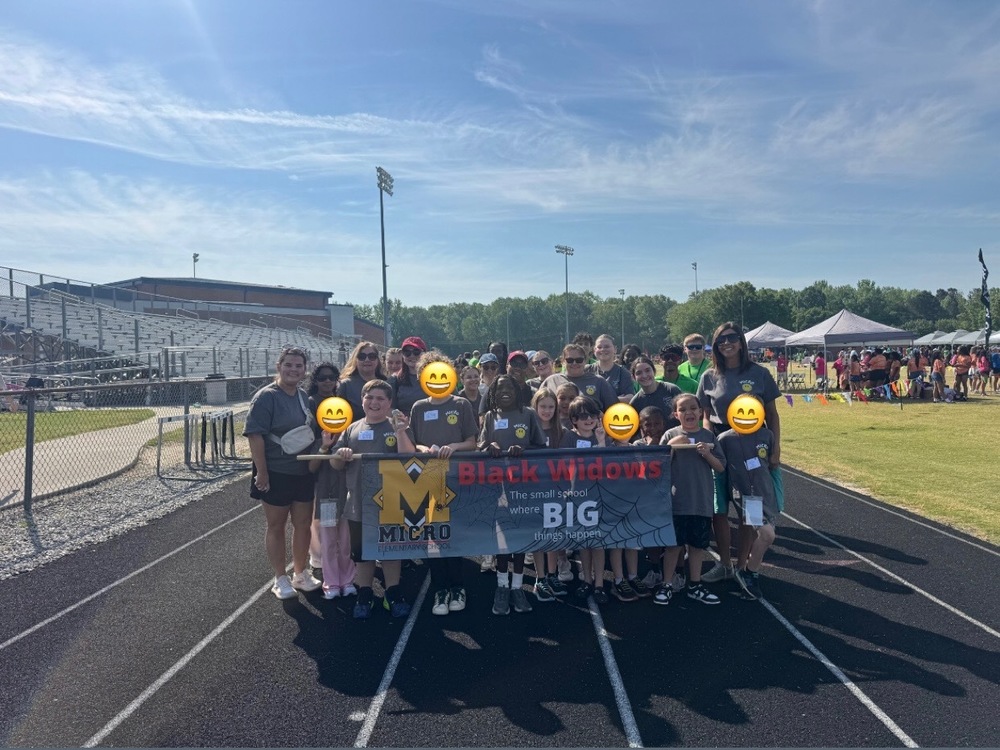 special olympic students holding school banner