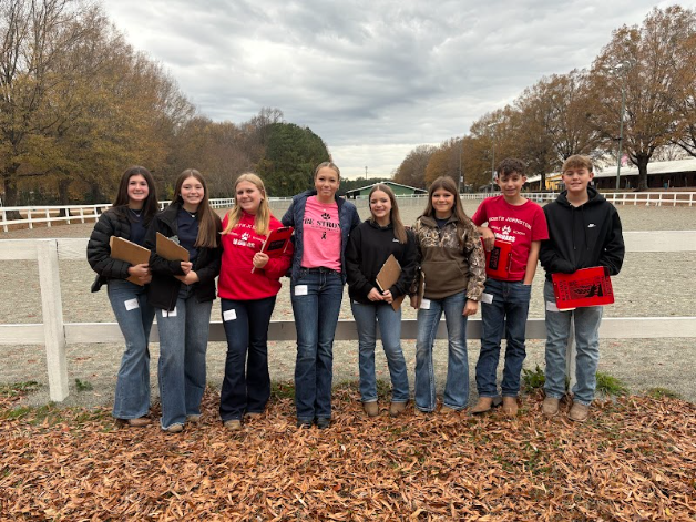 Picture of FFA members standing front of a fence
