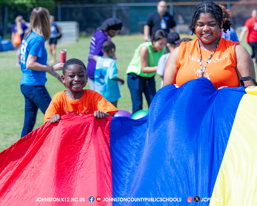 A student and his teacher are all smiles at the games.