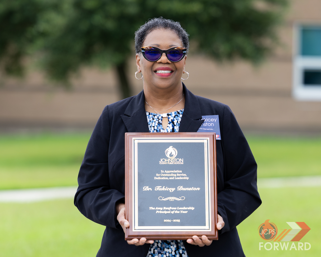 Takicey Dunston holds her award.