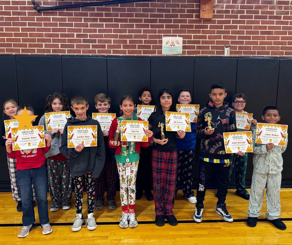 photo of spelling bee participants and winners holding their awards