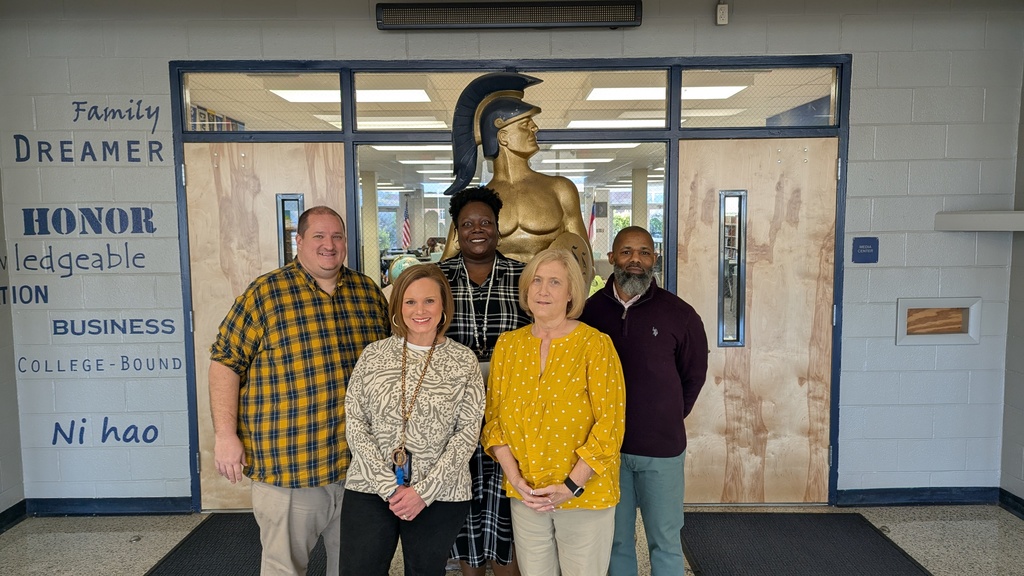 SSS Student Counselors standing in front of a statue