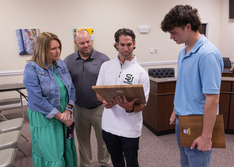 People looking at an award