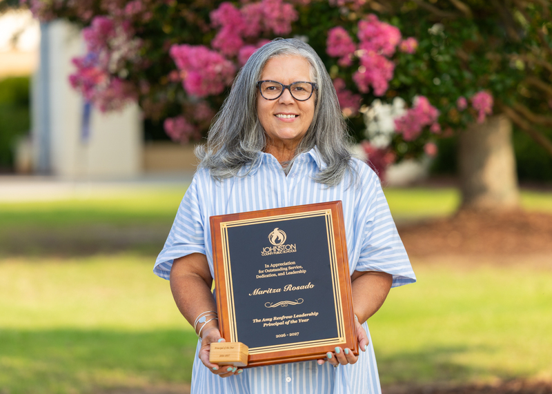 Maritza Rosado stands with her award for 2026 2027 Principal of the Year.