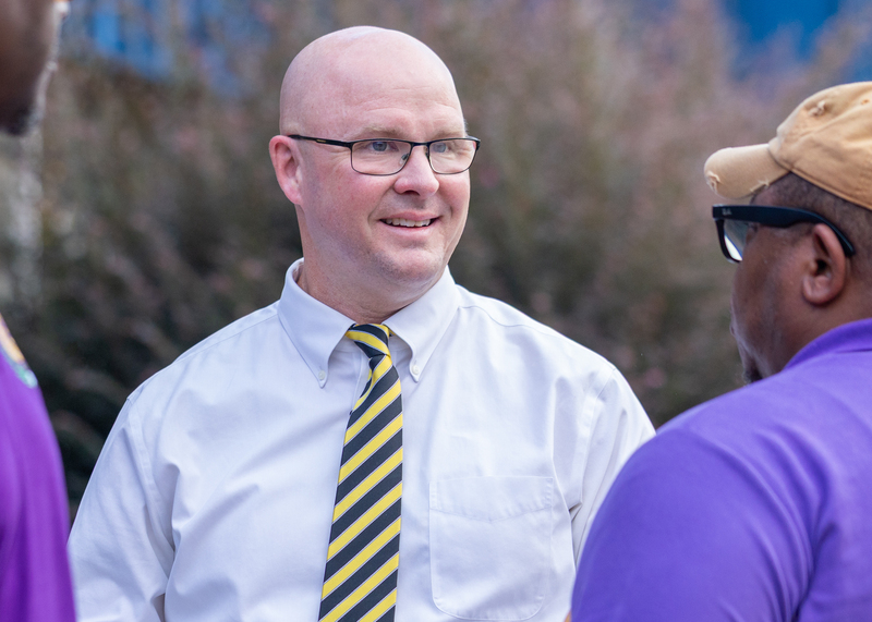 Smithfield Middle Principal Nicholas Taylor talks with community members before welcoming students back to school.