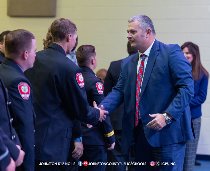 Dr. Pearce shaking hands with first responders