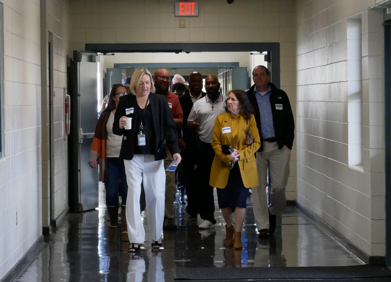 Mrs. Amanda Huber walks with guests as they tour CMS