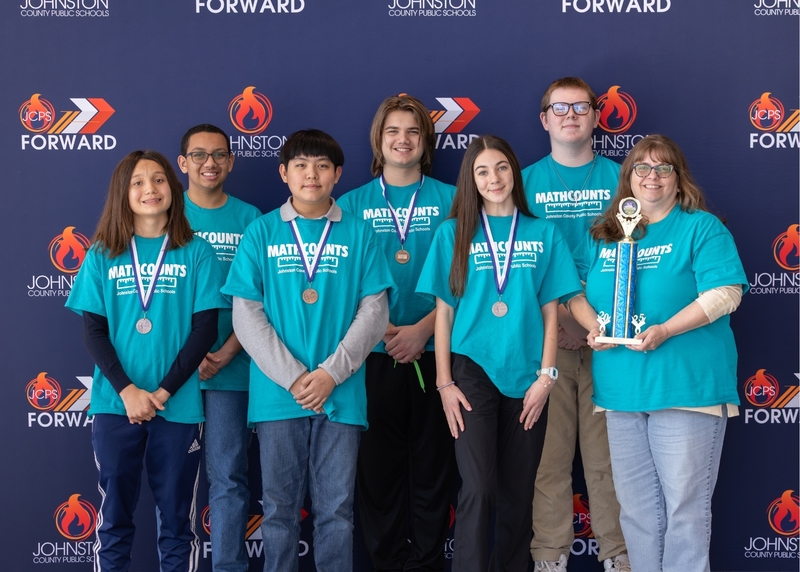 The Innovation Academy Pioneers team stand with their third place trophy.