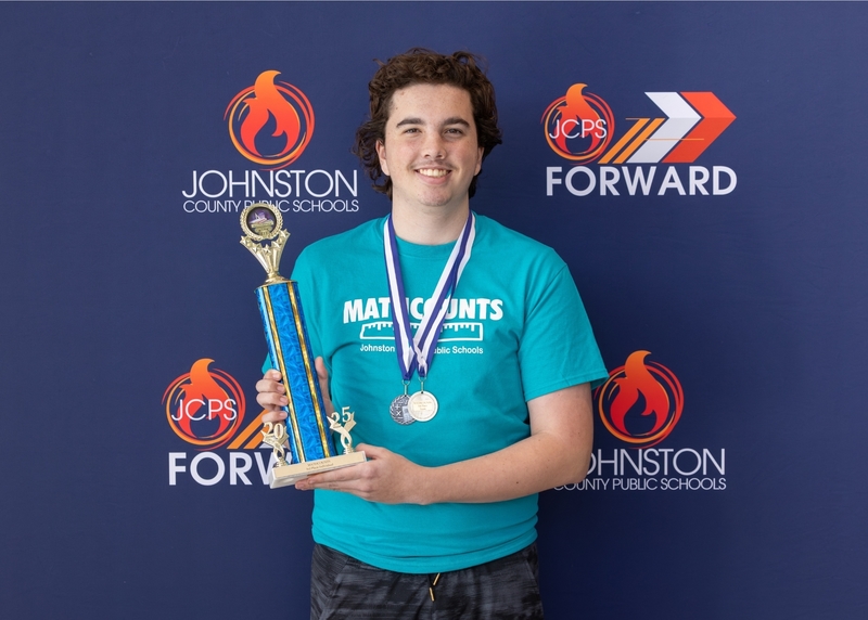 Benjamin Krakowsky proudly displays his trophy and medals for second place in the Countdown Round and third place in the Individual Category.