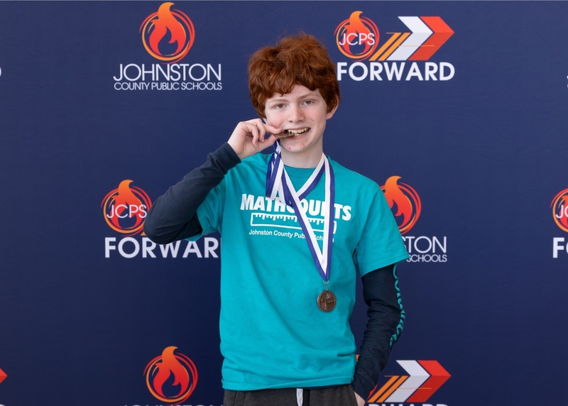 Luke Spears, a member of the Swift Creek Middle DiviDENS, shows off his medals for third place in the Countdown Round and Most Questions Answered Correctly in the Countdown Round.
