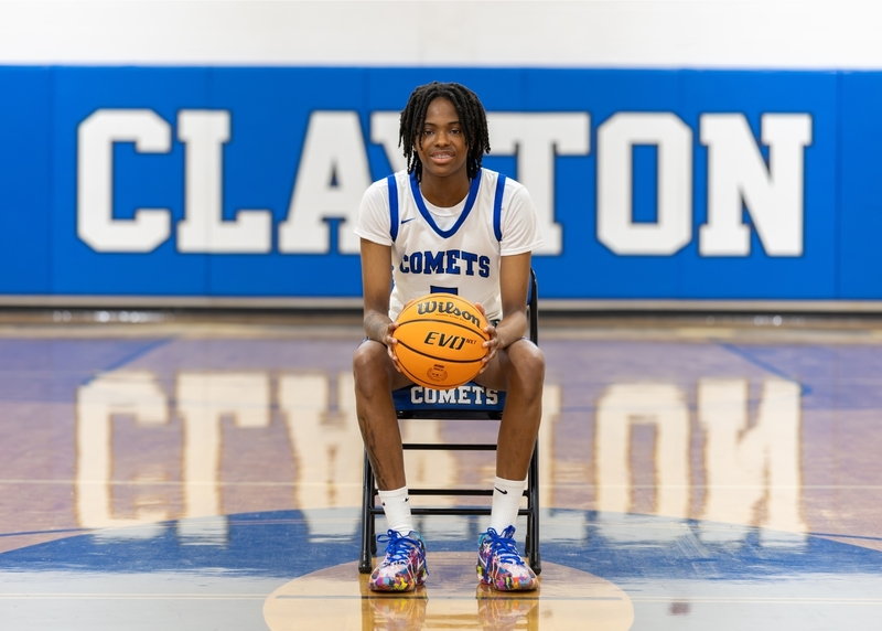 Y'Zana Randle sits on a chair with a basketball in hand