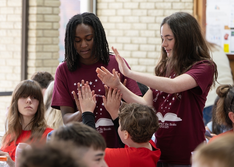 Two students high-five each other