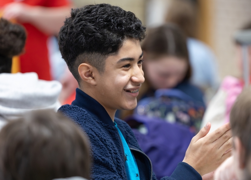 A boy claps at the Battle of the Books competition