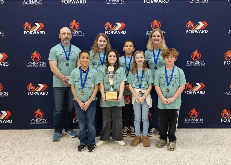 River Dell Elementary Battle of the Books team holds up the first place trophy in their team photo.