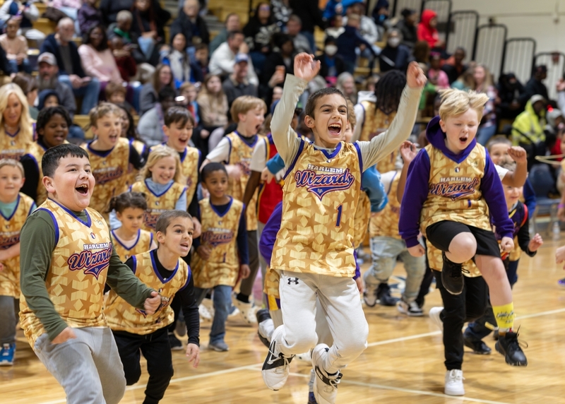Children of all ages run across the court at the Harlem Wizards game.