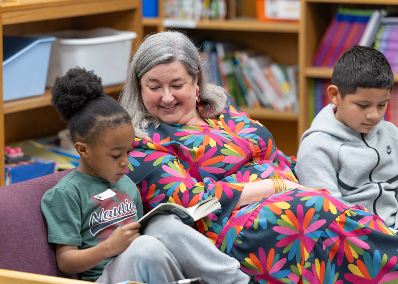 Lauren Strickland listens to a student read to her in the media center.