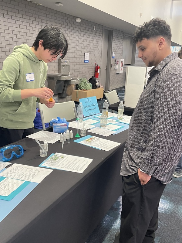 A student leads a hands-on activity.