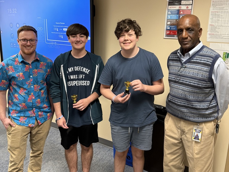 Winners of Science Night's best presentation pose with Mr. Shoaf and Mr. Daniels