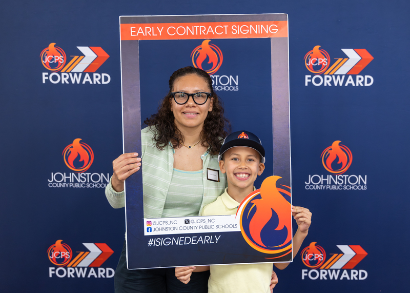 A mom and her son smile for a photo.