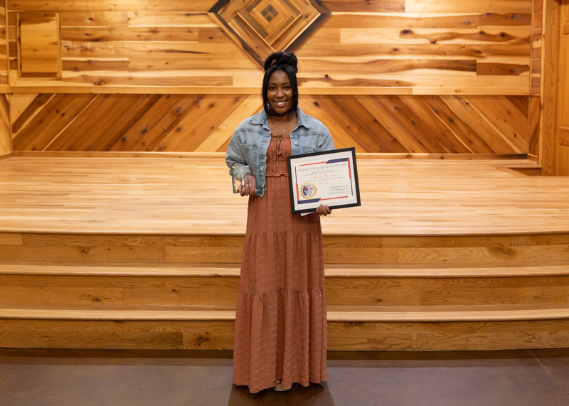 Moesha Gonzales holds her awards.
