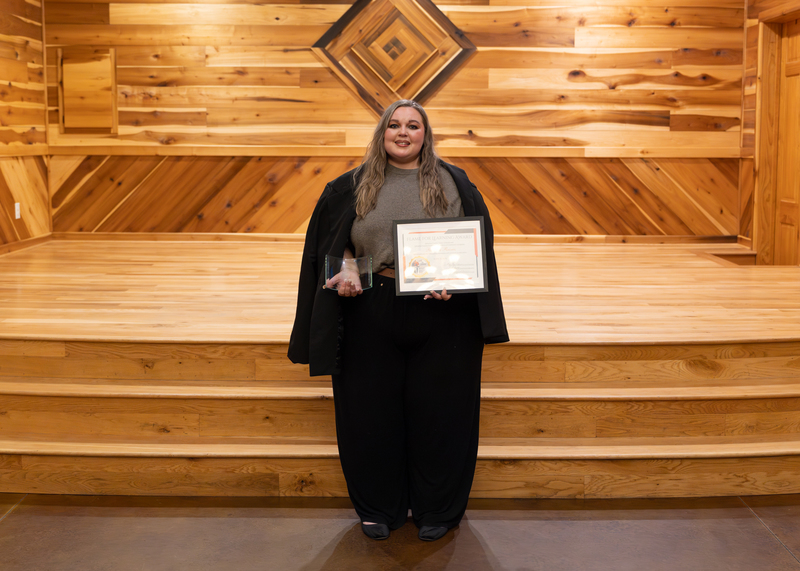 Rebecca Reeves holds her awards.