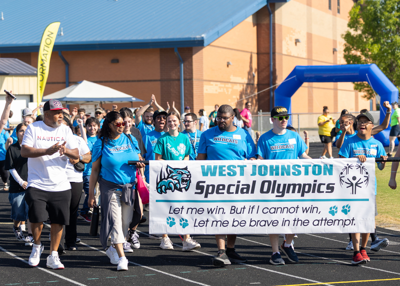 The West Johnston team carries their banner during the parade at the Special Olympics Johnston County Spring Games.