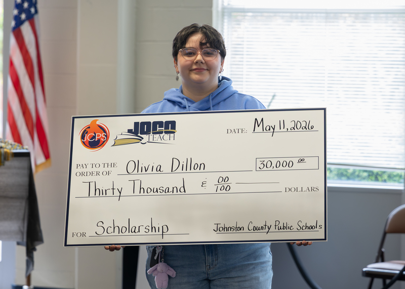 Olivia Dunn holding scholarship check