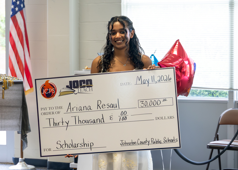 Ariana Resaul holds her scholarship check