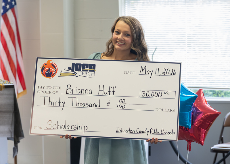 Brianna Huff holds her scholarship check