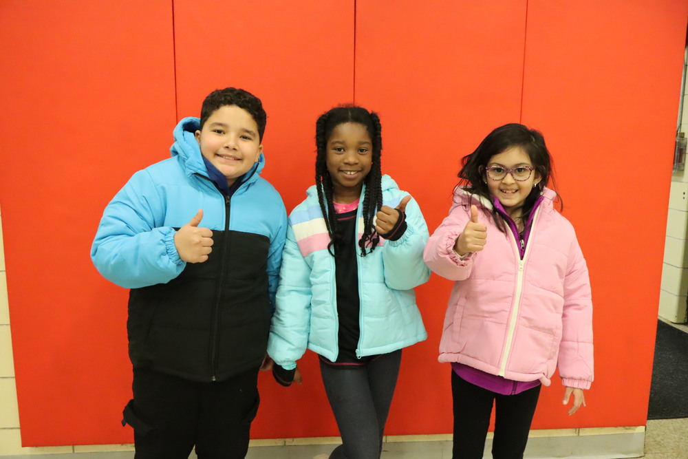 Three Culbertson students wearing new winter jackets