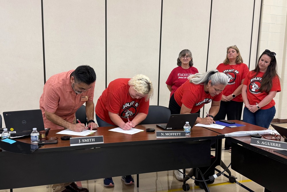School board president and teachers union officers sign new contract