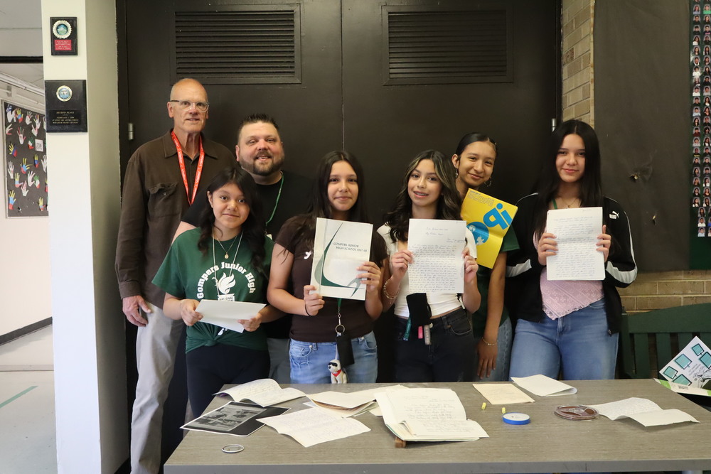 Gompers students, teacher and former Gompers student with items from the Time Capsule