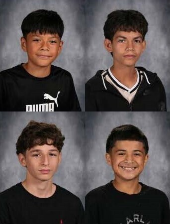 Four cross country student athletes