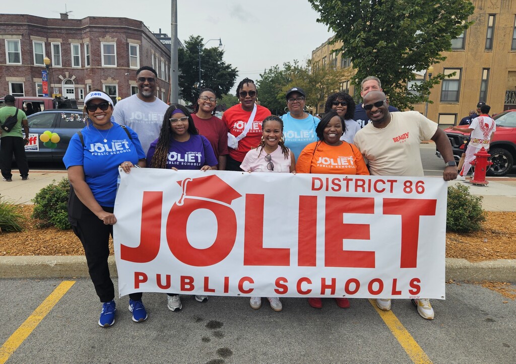 picture of administrators and banner at Black Joy Parade in Joliet