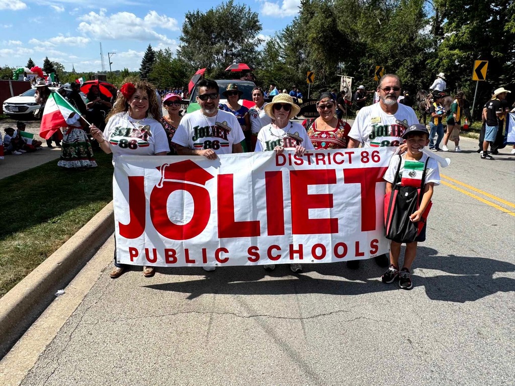 District 86 banner and school board members at parade