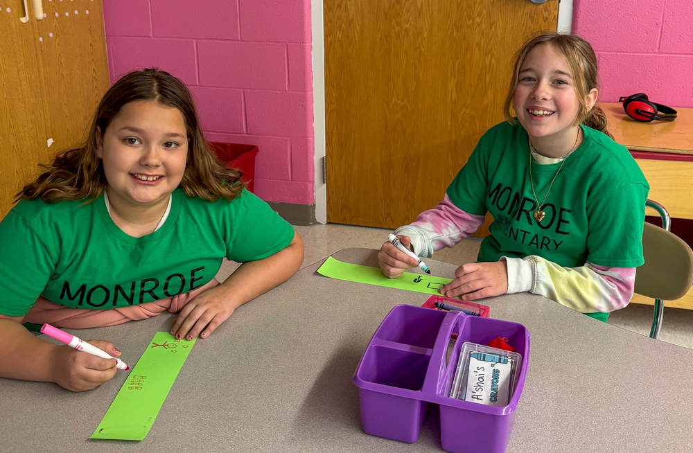 MES students smiling and writing