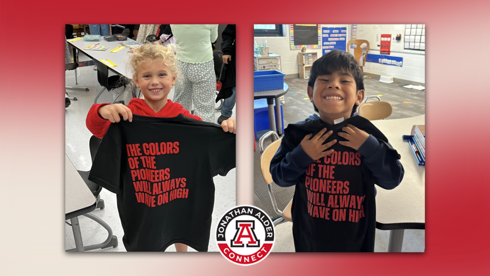MES and PCE students holding t-shirts