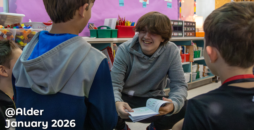 HS and MES students smiling and reading