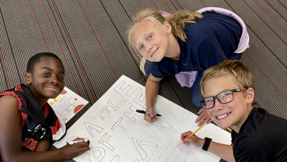 students creating a poster